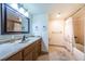 Bathroom with tub, shower, vanity and tiled floors at 7037 Sunset S Dr # 602, South Pasadena, FL 33707