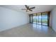 Living room with tile floors and sliding glass doors to balcony at 7037 Sunset S Dr # 602, South Pasadena, FL 33707