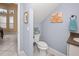 Small powder room with toilet and sink, beach-themed decor at 1217 Gorda Cay Ln, Punta Gorda, FL 33950