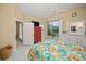 Bedroom with a queen bed, dresser, and sliding door to a patio at 1217 Gorda Cay Ln, Punta Gorda, FL 33950