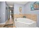 Bathroom with corner soaking tub and access to another bedroom at 1217 Gorda Cay Ln, Punta Gorda, FL 33950