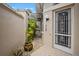 Charming side yard entry with a pergola, lush plants and tiled path at 1217 Gorda Cay Ln, Punta Gorda, FL 33950