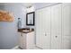 Guest bathroom with vanity, storage, and mirror at 1217 Gorda Cay Ln, Punta Gorda, FL 33950