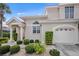 Front view of a two-story house with a garage and landscaping at 1217 Gorda Cay Ln, Punta Gorda, FL 33950