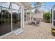 Relaxing patio with hot tub, seating area, and screened enclosure at 1217 Gorda Cay Ln, Punta Gorda, FL 33950