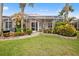 Spacious backyard oasis with screened enclosure and lush landscaping at 1217 Gorda Cay Ln, Punta Gorda, FL 33950