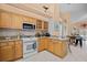 Well-equipped kitchen with light wood cabinets and granite countertops at 1217 Gorda Cay Ln, Punta Gorda, FL 33950