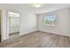 Light and airy bedroom featuring wood-look floors and an ensuite bathroom at 20461 Berrywood Ln, Tampa, FL 33647