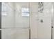 Clean shower with glass enclosure and white tile at 20461 Berrywood Ln, Tampa, FL 33647