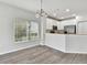 Bright dining room with wood-look flooring and kitchen views at 20461 Berrywood Ln, Tampa, FL 33647