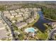 Aerial view of community with lake and numerous houses at 20461 Berrywood Ln, Tampa, FL 33647