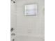 Shower with white tile and a window for natural light at 20461 Berrywood Ln, Tampa, FL 33647