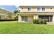 Ground level patio with adjacent grassy backyard at 20461 Berrywood Ln, Tampa, FL 33647