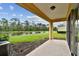 Covered patio overlooking a serene lake and lush greenery at 20461 Berrywood Ln, Tampa, FL 33647