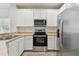 Stainless steel appliances and white cabinets in this updated kitchen at 20461 Berrywood Ln, Tampa, FL 33647