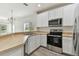 Modern kitchen with stainless steel appliances and an eat-in island at 20461 Berrywood Ln, Tampa, FL 33647