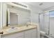 Bathroom with double vanity, shower, and tile flooring at 20461 Berrywood Ln, Tampa, FL 33647