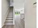 Bright entryway with stairs leading upstairs and a view into the living area at 20461 Berrywood Ln, Tampa, FL 33647
