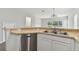 Kitchen with stainless steel dishwasher and corner sink at 20461 Berrywood Ln, Tampa, FL 33647