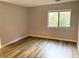 Bright bedroom with wood-look floors and a large window at 13367 Arbor Pointe Cir # 204, Tampa, FL 33617