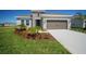 Charming single-story home featuring a well-manicured lawn, tasteful landscaping, and a neutral color scheme at 11963 Richmond Trl, Parrish, FL 34219