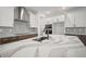 Modern kitchen features white cabinets, stainless steel appliances, and marble countertops at 11963 Richmond Trl, Parrish, FL 34219