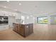 Open-concept kitchen with an island, stainless steel appliances, and seamless flow into the spacious living area at 11963 Richmond Trl, Parrish, FL 34219
