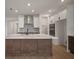 Bright, modern kitchen featuring a center island, stainless steel appliances, a walk-in pantry, and ample storage at 11963 Richmond Trl, Parrish, FL 34219
