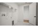 Clean laundry room with open shelving at 11963 Richmond Trl, Parrish, FL 34219