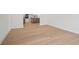 Bright living room with wood floors and view to the kitchen at 11963 Richmond Trl, Parrish, FL 34219