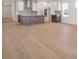Spacious open-concept living area with wood floors and view to kitchen at 11963 Richmond Trl, Parrish, FL 34219