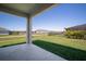 Covered patio overlooking a spacious backyard with lush green grass and clear blue skies at 11963 Richmond Trl, Parrish, FL 34219