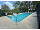 Clean and refreshing community pool with plenty of lounge chairs at 1919 Whispering Way, Tarpon Springs, FL 34689