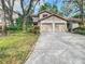 Front view of two-story townhome with double garage at 1919 Whispering Way, Tarpon Springs, FL 34689