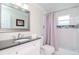 Clean bathroom, with updated vanity and shower/tub combo at 9717 N Rome Ave, Tampa, FL 33612