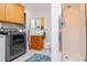 Main floor bathroom with shower, toilet and washer/dryer hookups at 9717 N Rome Ave, Tampa, FL 33612