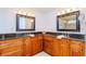 Double vanity bathroom with granite countertops and large mirrors at 9717 N Rome Ave, Tampa, FL 33612