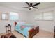 Bright bedroom with a ceiling fan and wood flooring at 9717 N Rome Ave, Tampa, FL 33612
