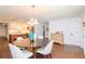 Open concept dining area with kitchen view, hardwood floors, and chandelier at 9717 N Rome Ave, Tampa, FL 33612