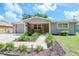 Gray house with brick accents, landscaped yard, and attached garage at 9717 N Rome Ave, Tampa, FL 33612