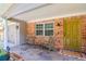 Inviting front porch with brick columns, seating area, and a welcoming mat at 9717 N Rome Ave, Tampa, FL 33612