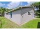 Gray house exterior with a well-maintained lawn at 9717 N Rome Ave, Tampa, FL 33612