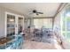 Sunroom with glass doors and windows, creating a light and airy space at 9717 N Rome Ave, Tampa, FL 33612