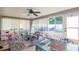 Bright sunroom features ample seating, a ceiling fan, and access to the backyard at 9717 N Rome Ave, Tampa, FL 33612