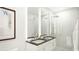Spa-like bathroom with double sinks and large shower at 411 E Shore Drive # 213, Clearwater Beach, FL 33767