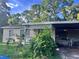 Small house with carport and mature trees at 403 6Th Sw Ave, Ruskin, FL 33570