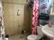 Bathroom with shower/tub combo and pink curtain at 403 6Th Sw Ave, Ruskin, FL 33570