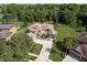 Aerial view of a two-story house with a stone fireplace and copper roof at 16637 Ashton Green Dr, Lutz, FL 33558