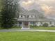 House exterior with red door and landscaping at 15324 Balm Wimauma Rd, Wimauma, FL 33598