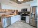 Updated kitchen featuring stainless steel appliances and white cabinets at 19725 Gulf Blvd # 33, Indian Shores, FL 33785